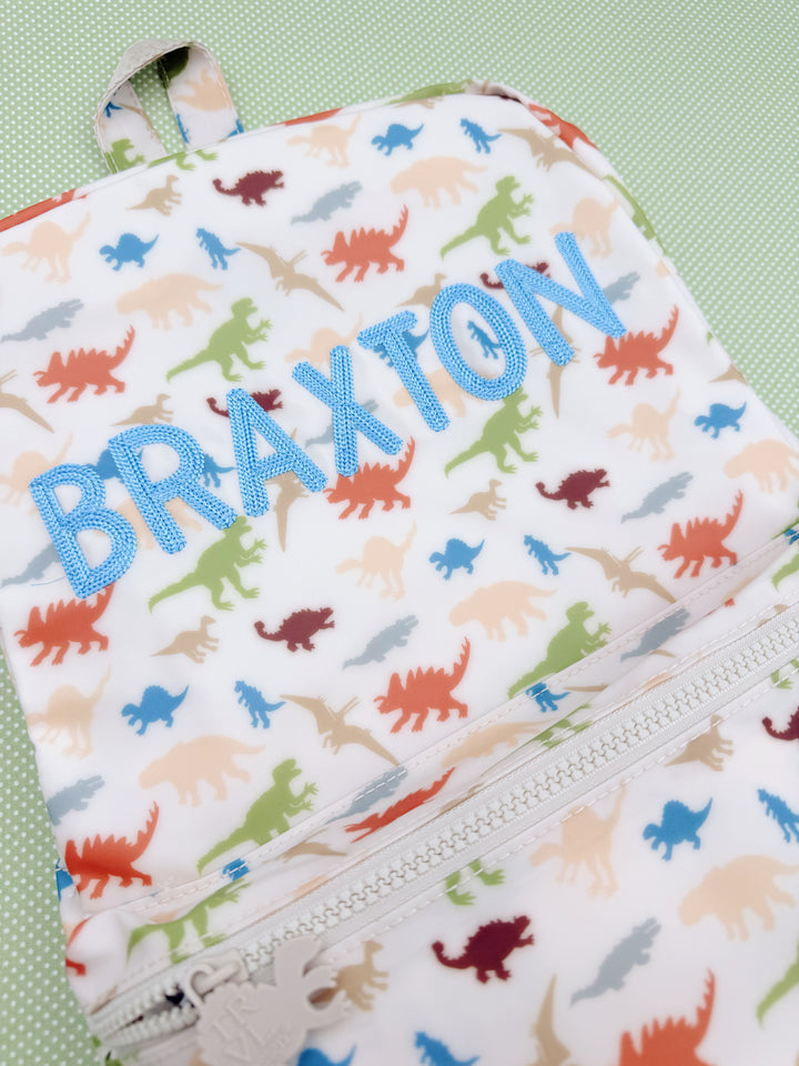 TRVL Backpacker in April Bold Chain Stitch, Dino-Roar
